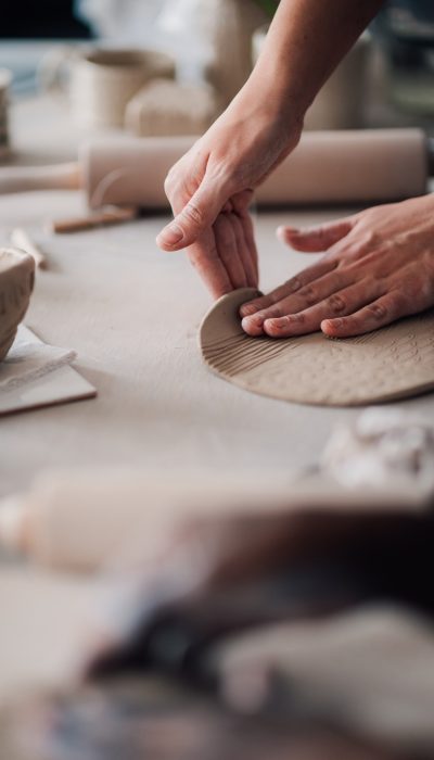 Close up of pottery designer making earthenware at ceramics studio.